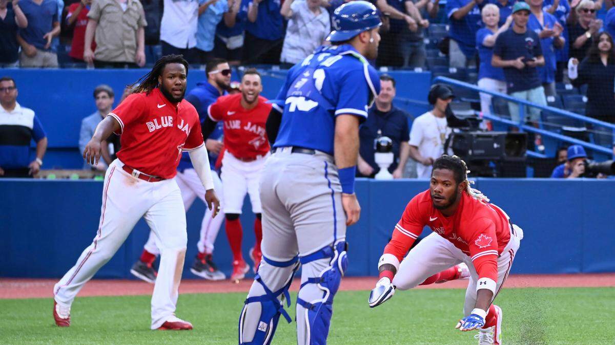 Toronto Blue Jays’ Raimel Tapia scores the winning run on a single by Teoscar Hernandez against the Kansas City Royals during the 10th inning of a baseball game in Toronto, Saturday, July 16, 2022. (Jon Blacker/The Canadian Press via AP)