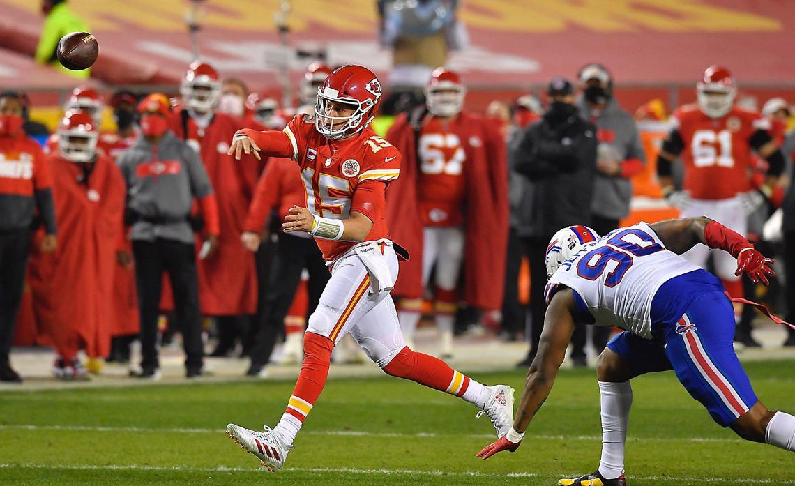 Kansas City Chiefs quarterback Patrick Mahomes throws a pass in the first half while being pressured by Buffalo Bills defensive tackle Quinton Jefferson Sunday, January 24, 2021, during the AFC Championship Game at Arrowhead Stadium in Kansas City, Missouri.