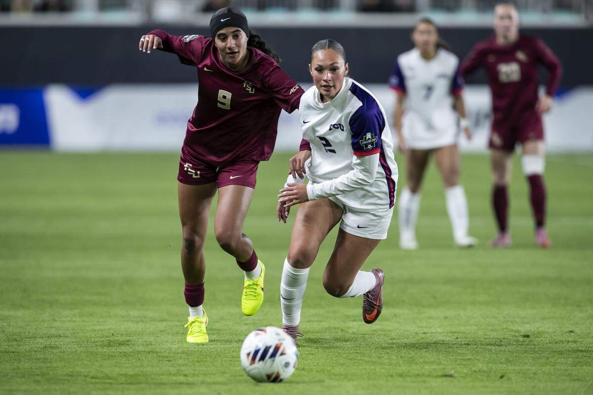 TCU midfielder Sydney Becerra, right, dribbles the ball up the field against Florida State forward Taylor Suarez during a College Cup NCAA Division I women’s soccer semifinal match at CPKC Stadium in Kansas City, Missouri on Friday, Dec. 5, 2025. The Seminoles beat the Horned Frogs to advance.