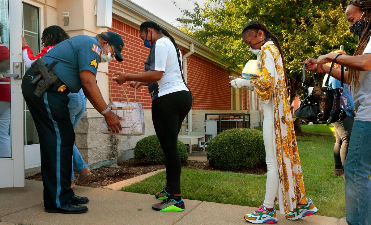 Dwight Davis of Strikeforce Security checks the purse of LaTosha Bryant for weapons as she enters The Church of Jesus Christ of Latter-day Saints on McPherson Avenue for the funeral of her niece Deosha “Princess” Purnell, 15, on Friday, Sept. 25, 2020. Deosha, 15, was shot near a Riverview gas station and later died at a hospital.
