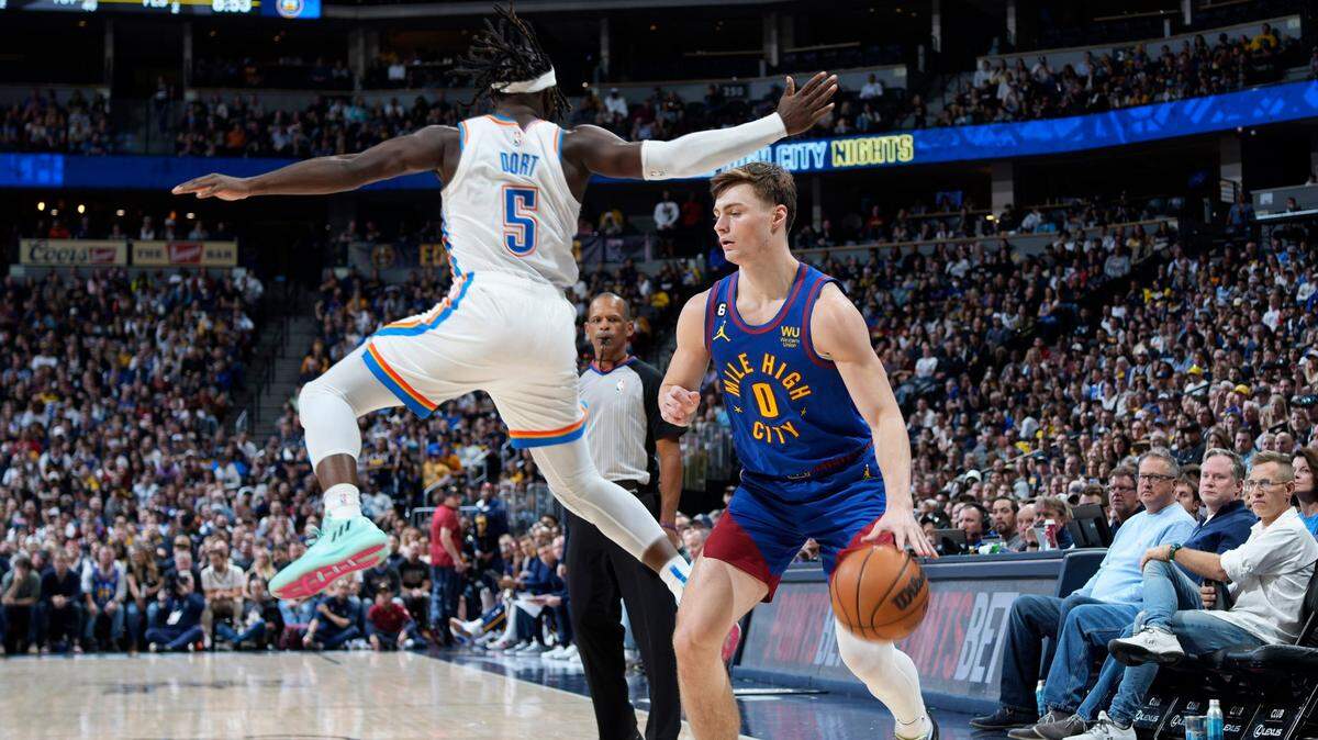 Denver Nuggets guard Christian Braun, right, dodges Oklahoma City Thunder forward Luguentz Dort during the second half of Saturday’s game in Denver. (AP Photo)