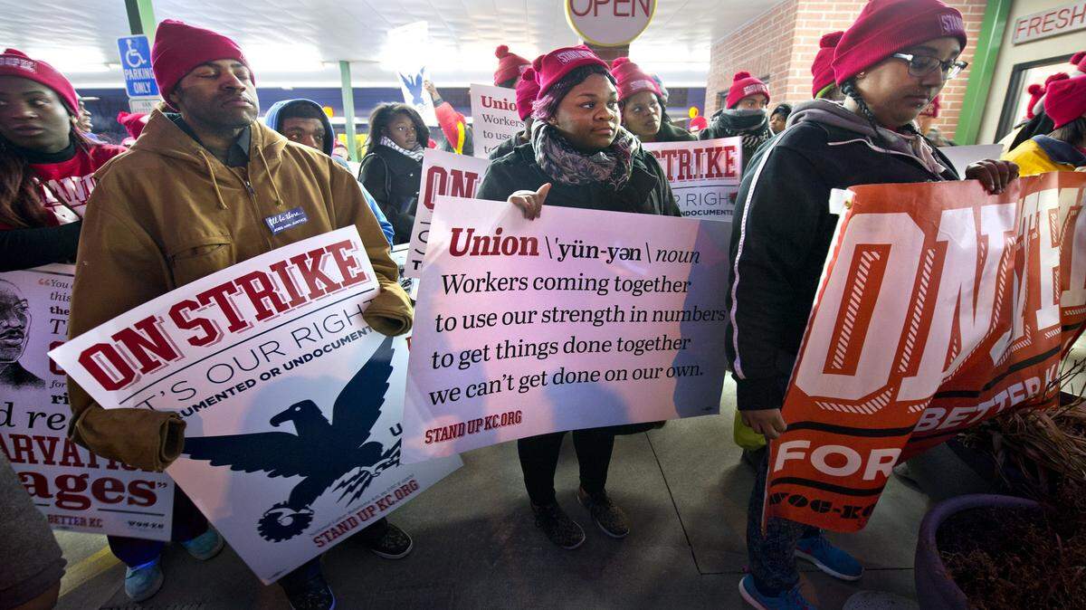 Low-wage workers listened to speakers while demonstrating Dec. 4 at the Sonic Drive-In at 920 State Ave. in Kansas City, Kan. They also demonstrated at a nearby McDonald's and a Phillips 66 gas station at 47th and State Avenue. Cost-of-living adjustments built into Missouri’s minimum wage law will push the state’s wage floor up to $7.65 an hour on Jan. 1. Workers in Kansas fall under the federal rate, which has not been raised since 2009.