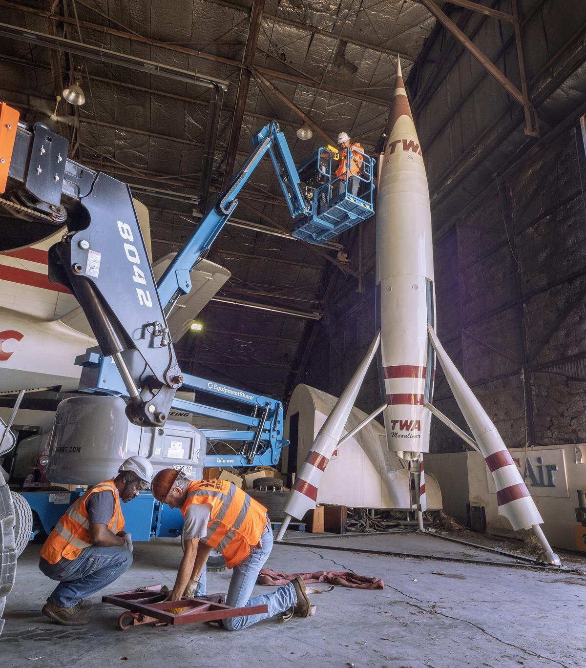A Belger Cartage crew prepares the TWA Moonliner II to be moved Saturday at the Kansas City Downtown Airport-Wheeler Field.
