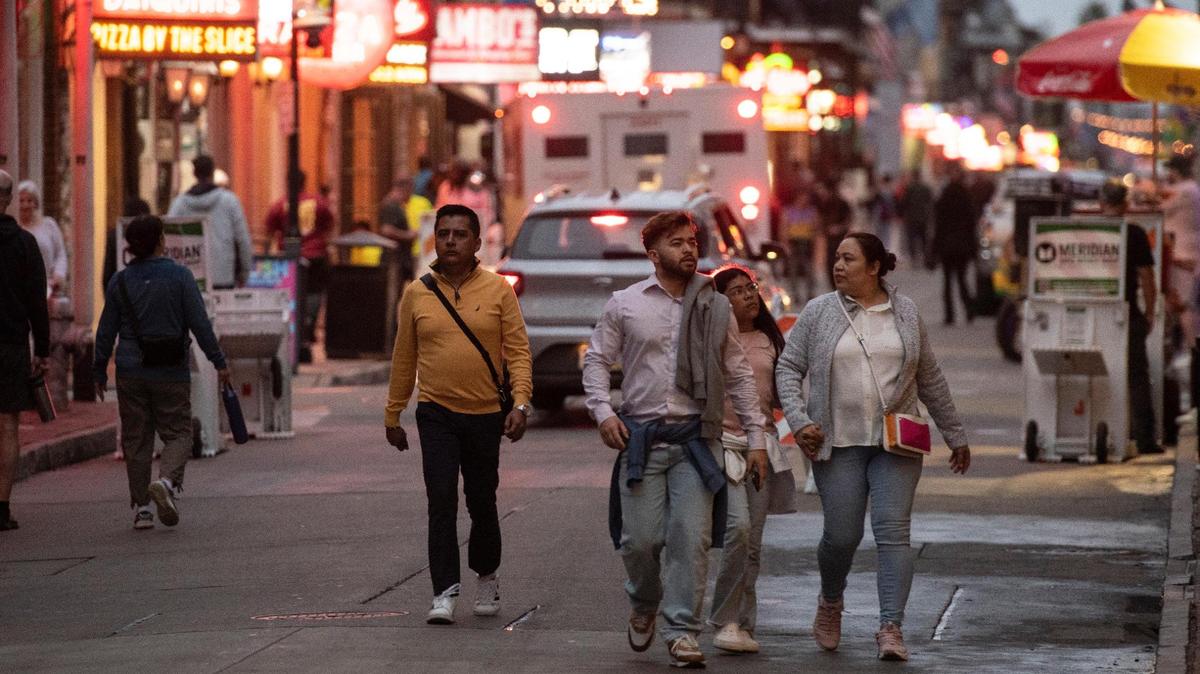 Tourists walk along Bourbon Street in New Orleans on Thursday. Visitors for the Super Bowl can expect to see more law enforcement officers in the district.