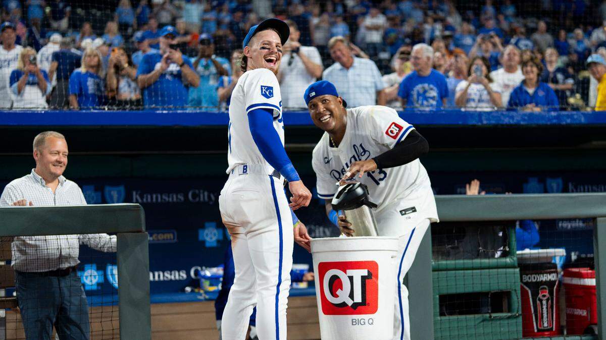 Kansas City Royals shortstop Bobby Witt Jr. (7) and catcher Salvador Perez (13) get ready to splash left fielder MJ Melendez (not pictured) after defeating the Los Angeles Angels at Kauffman Stadium on Aug. 21, 2024.