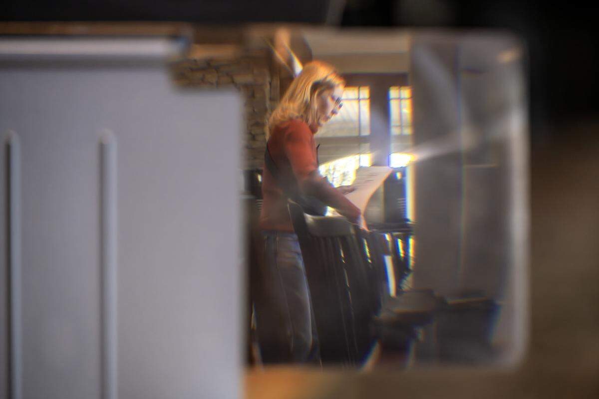 A voter is seen through a ballot magnifier while they cast their vote at Thousand Oaks Oasis Pool and Clubhouse during Election Day on Tuesday, April 7, 2026, in Parkville.