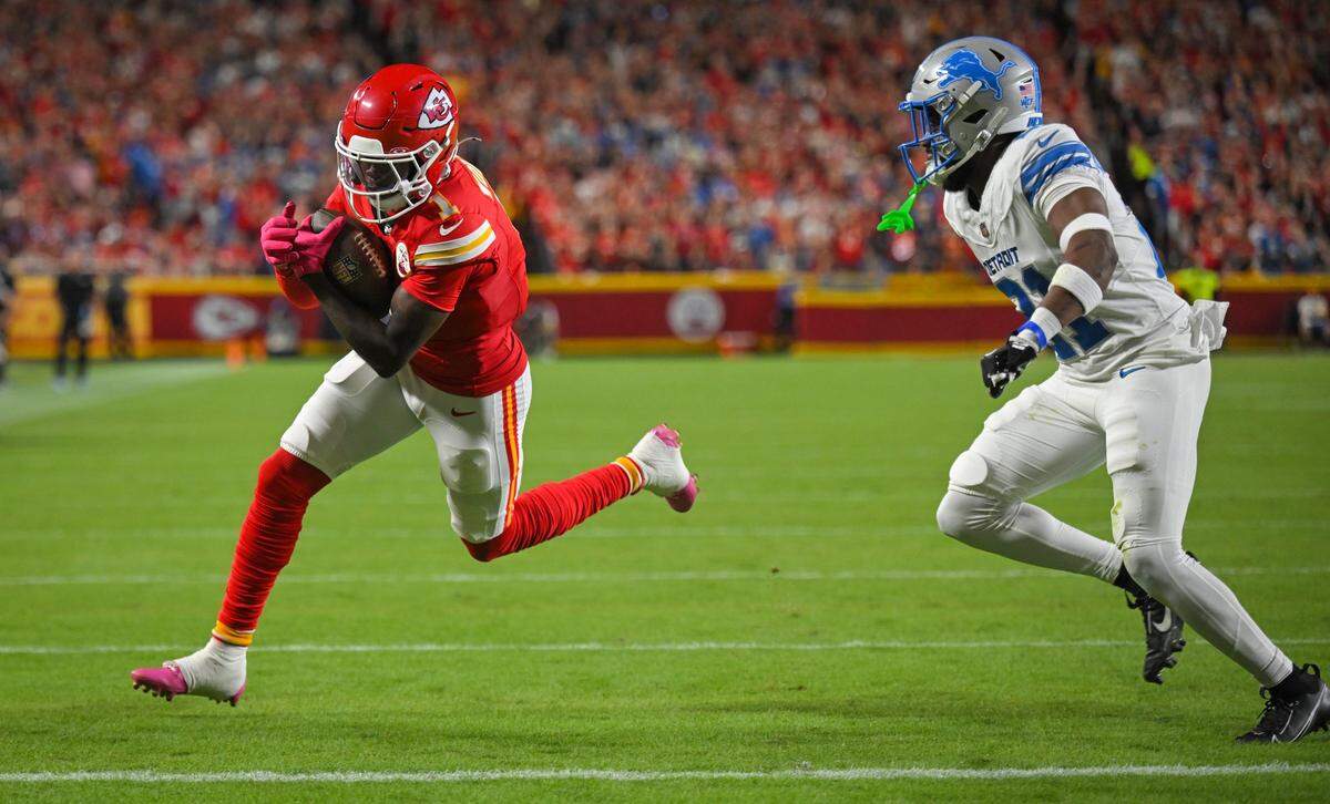 Kansas City Chiefs wide receiver Xavier Worthy (1) runs in for a touchdown past the defense of Detroit Lions cornerback Amik Robertson (21) in the first quarter on Sunday, Oct. 12, 2025, at GEHA Field at Arrowhead Stadium.