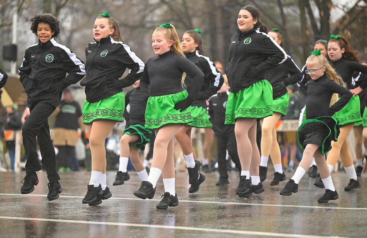 Members of the O’Riada Manning Academy of Irish Dance performed an Irish dance in the rain during the 2023 Brookside St. Patrick’s Day Warm-Up Parade on Saturday March 11, 2023 in Kansas City.
