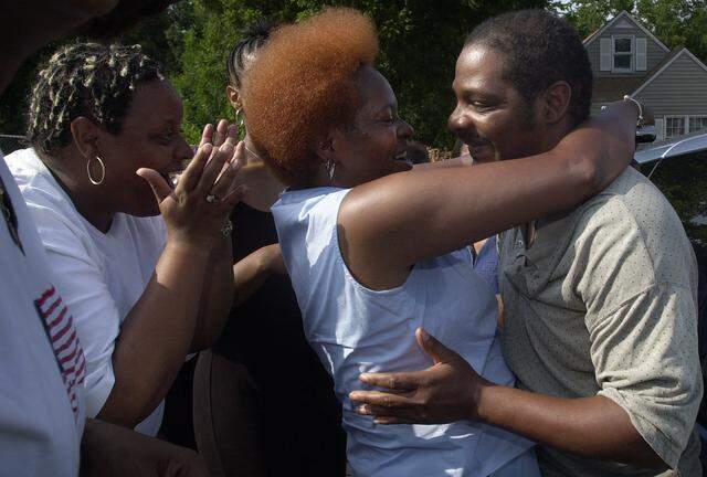 After his release from prison in 2003, Joe Amrine, right, was greeted by his sisters Renee, center, and Marva.