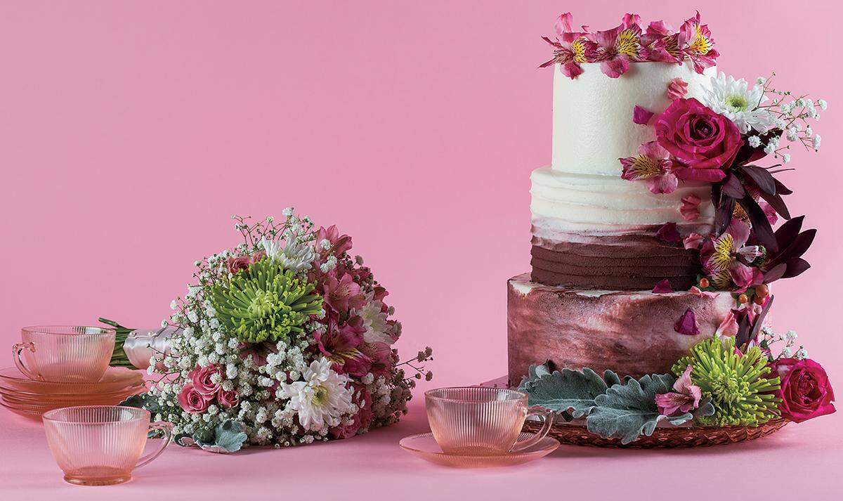PRETTY IN PNK A bouquet of daisies, baby's breath, roses, spider mums and alstroemeria from Floral Accents. Rich layers of buttercream top off a jewel-toned creation from It's A Sweet Treat Day Bakery. Pink glass cake plate available to rent from Ultrapom.