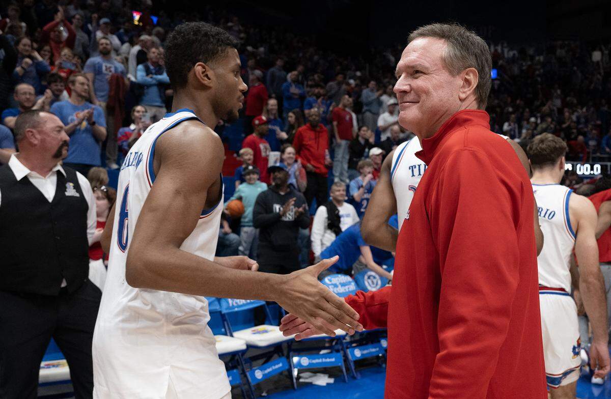 Kansas coach Bill Self greets forward Samis Calderon (6) as they walk off the court after the Jayhawks defeated TCU 104-100 in overtime at Allen Fieldhouse in Lawrence on Tuesday, Jan. 6, 2025.