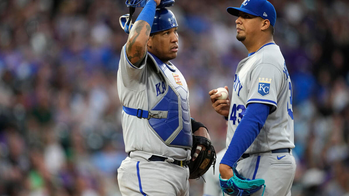 Kansas City Royals catcher Salvador Perez, left, talks with starting pitcher Carlos Hernandez, who had given up an RBI double to Colorado Rockies’ Brendan Rodgers during the fifth inning of a baseball game Saturday, May 14, 2022, in Denver. (AP Photo/David Zalubowski)