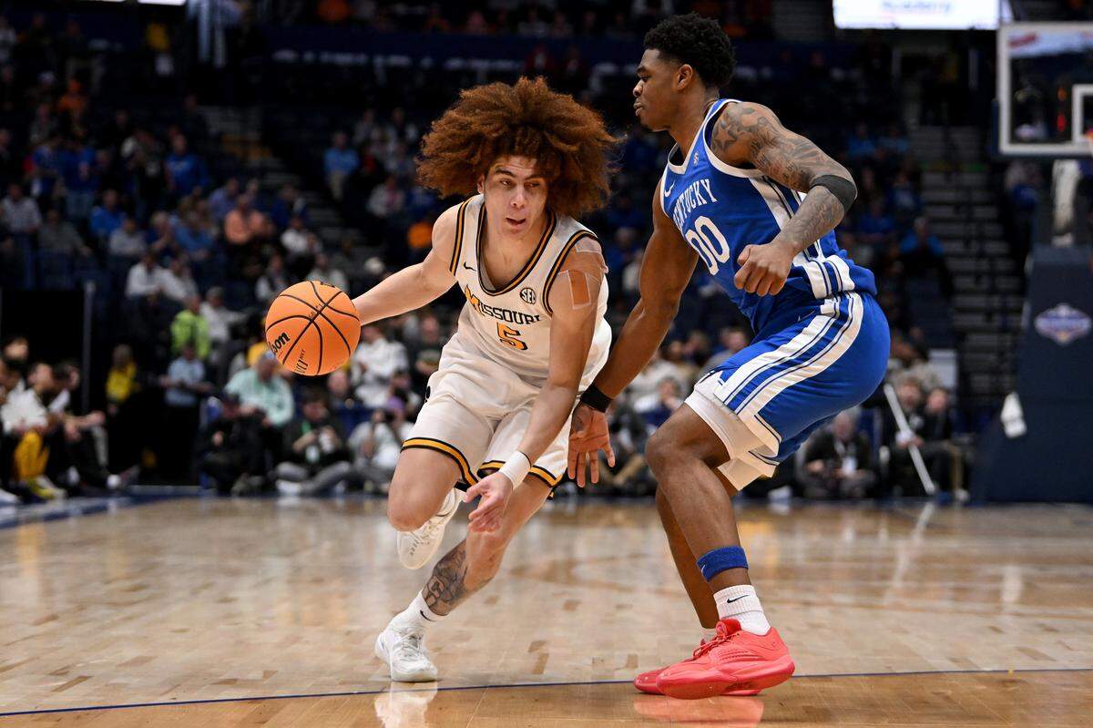NASHVILLE, TENNESSEE - MARCH 12: T.O. Barrett #5 of the Missouri Tigers drives to the basket against Otega Oweh #00 of the Kentucky Wildcats during the first half in the second round of the 2026 SEC Men's Basketball Tournament at Bridgestone Arena on March 12, 2026 in Nashville, Tennessee. (Photo by Carly Mackler/Getty Images)