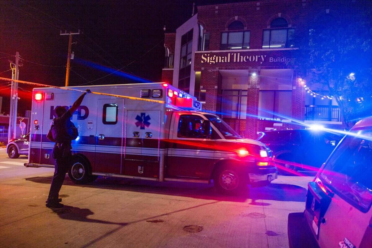 Police squad cars light up the sky after a shooting near the intersection of Westport Road and Mill Street on Wednesday, July 1, 2026.