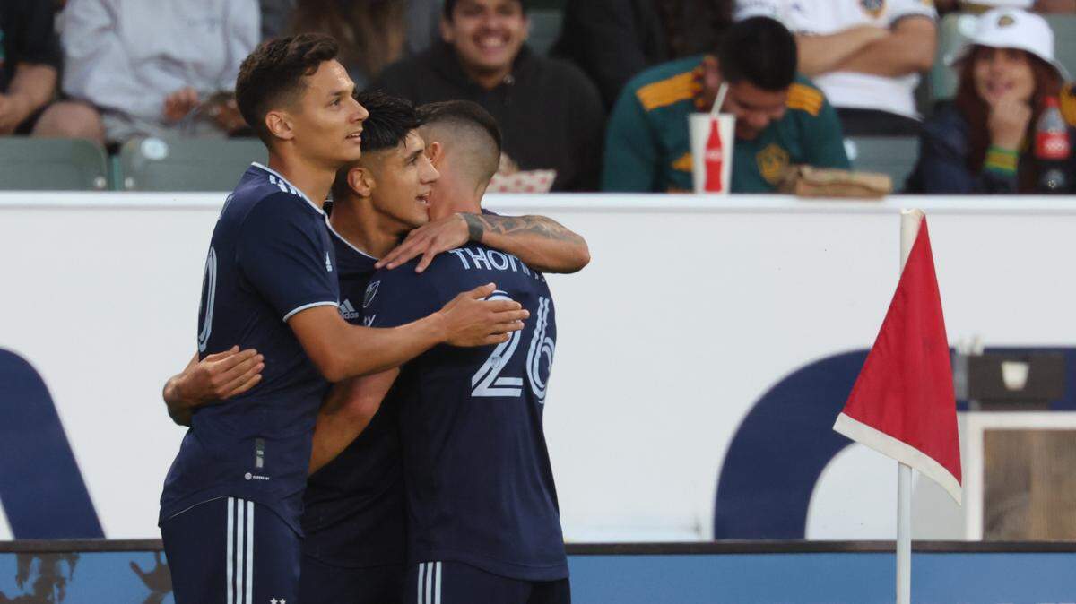 Sporting Kansas City forward Alan Pulido (9) celebrates with teammates after scoring a goal during the first half against LA Galaxy at Dignity Health Sports Park on June 21, 2023.