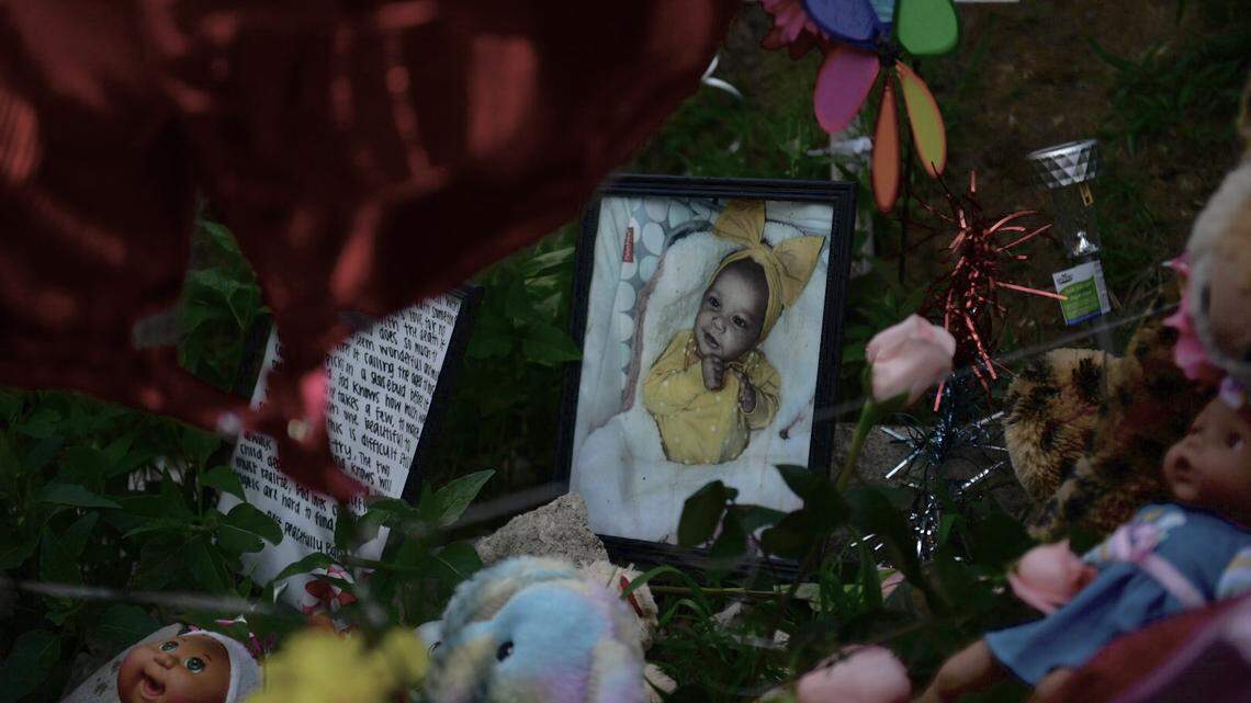 A memorial sits near the woods where 6-month-old Kha’liya Bridgewater was found dead on May 13, 2023, in east Kansas City.