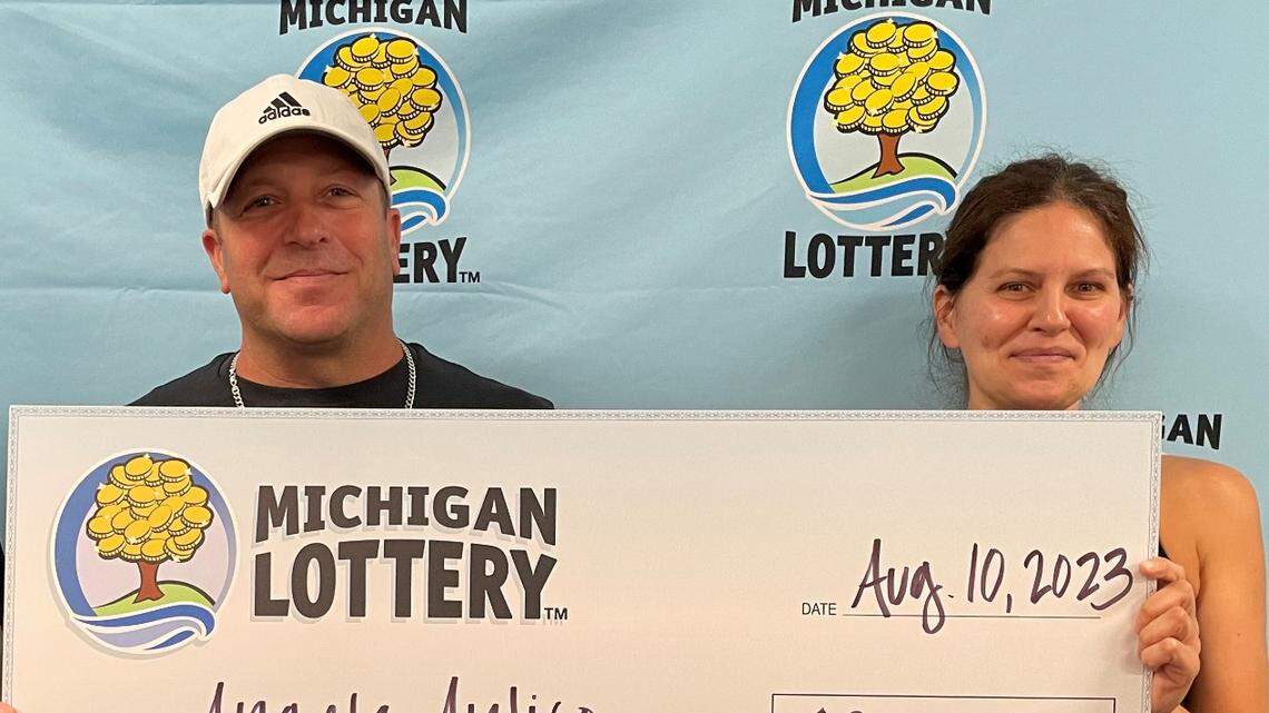 Angela Antico and her husband, Paul, receive their oversized check.