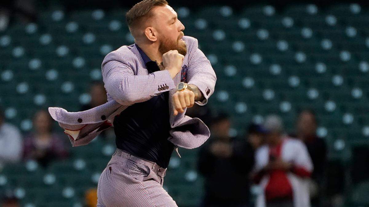 MMA fighter Conor McGregor throws out a ceremonial first pitch before a baseball game between the Chicago Cubs and the Minnesota Twins Tuesday, Sept. 21, 2021, in Chicago. (AP Photo/Charles Rex Arbogast)