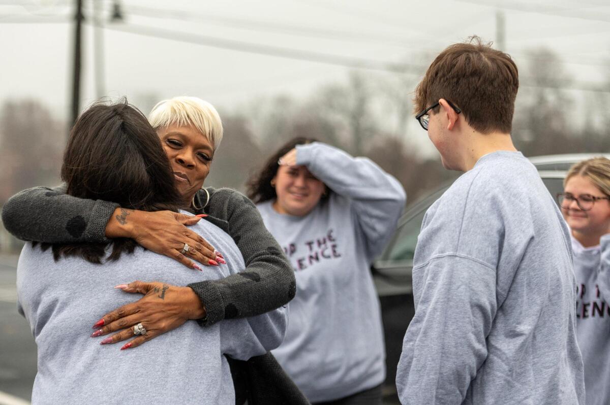 Grace Prince warmly embraces volunteers as they assist her with gifts during the Mothers in Charge Christmas Giveaway event held at the Robert J. Mohart Multi-Purpose Center on Saturday, Dec. 16, 2023, in Kansas City.