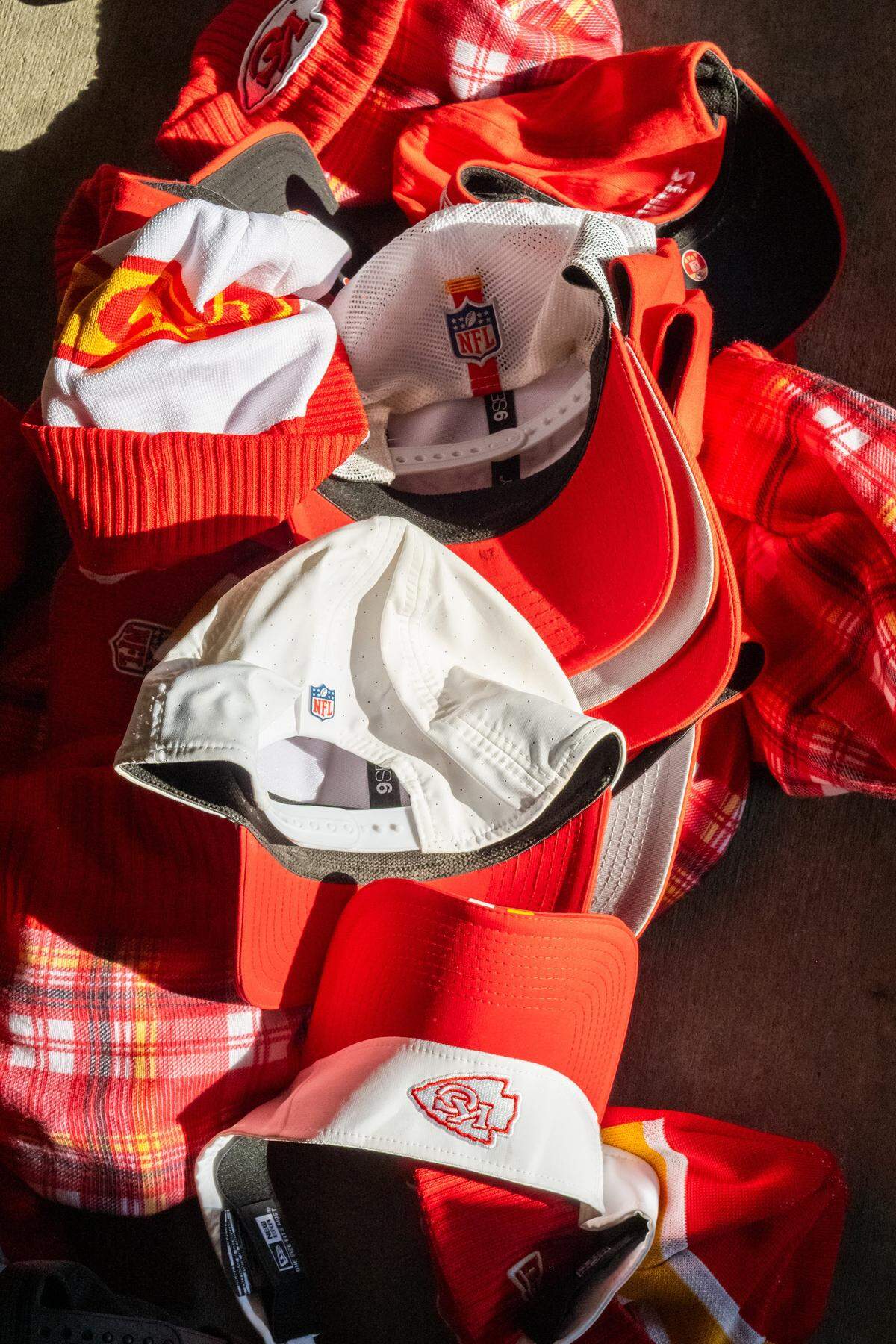 A pile of player worn hats at The Pavilion at GEHA Field at Arrowhead Stadium on Friday, February 20, 2026. Fans can come and shop on Saturday for items such as game worn jerseys, practice gear, and cleats.