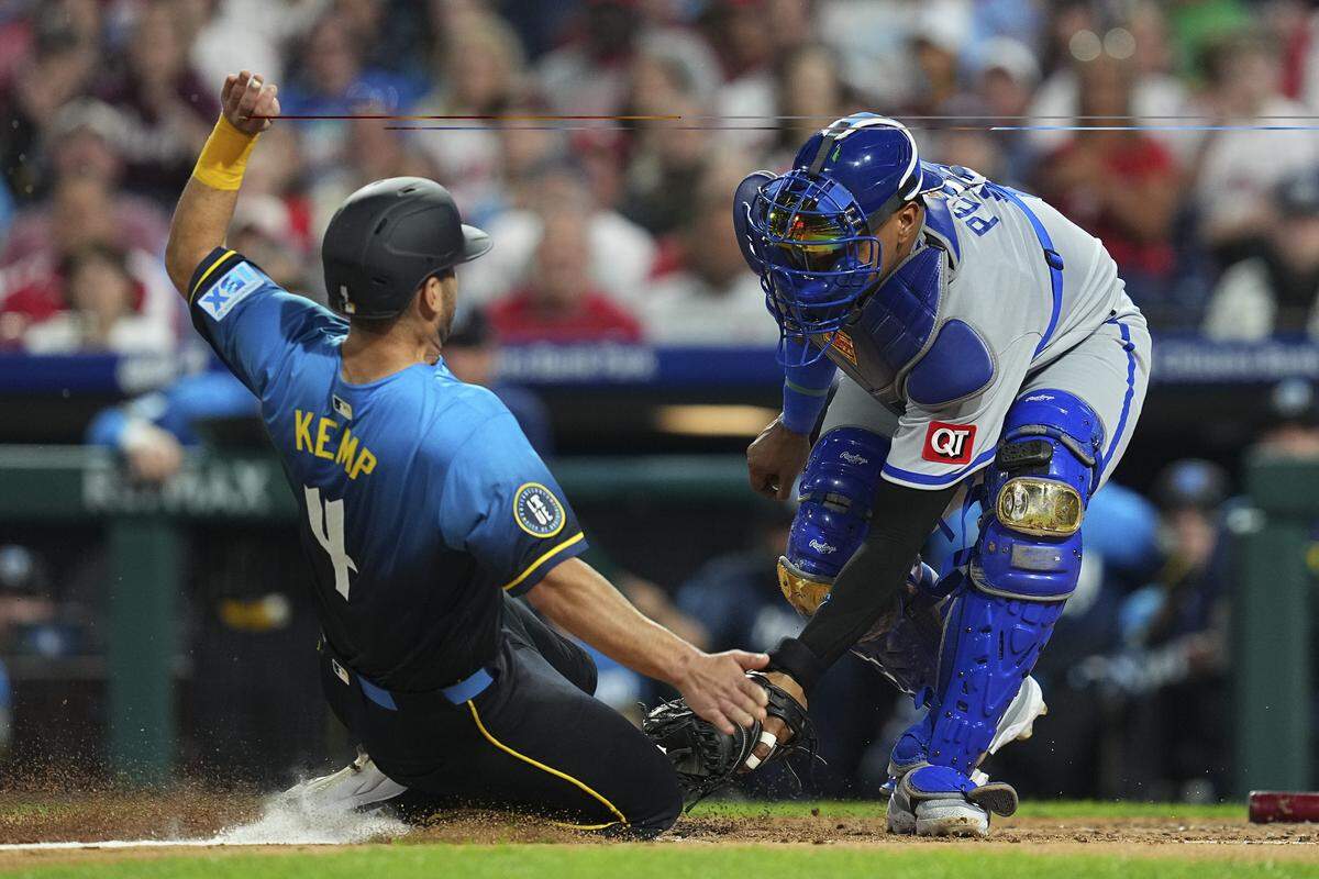 Salvador Perez #13 of the Kansas City Royals tags out Otto Kemp #4 of the Philadelphia Phillies in the bottom of the third inning at Citizens Bank Park on September 12, 2025 in Philadelphia, Pennsylvania. The Phillies defeated the Royals 8-2.