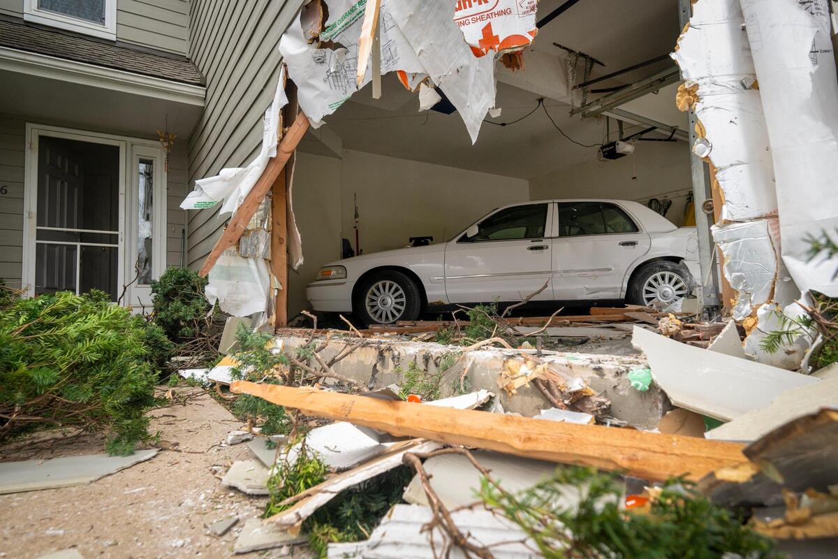 A car inside the garage when another vehicle smashed into the house.