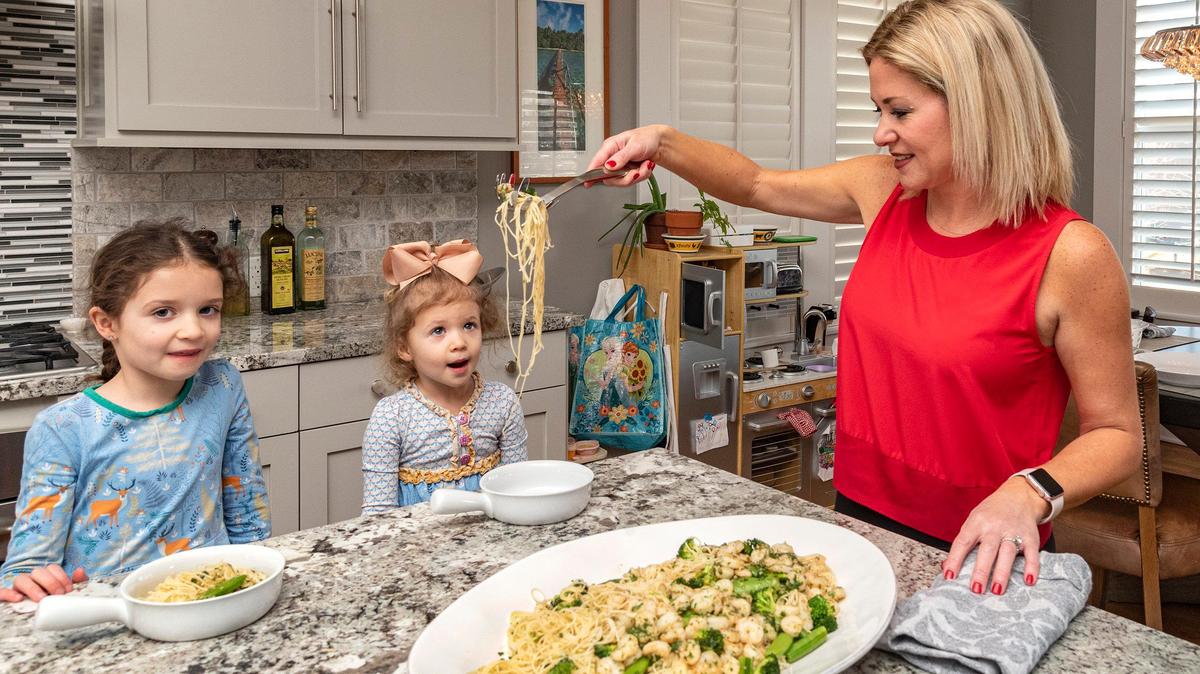 Megan Nordstrom serves brown butter shrimp pasta to her daughters, Finley, 6, left, and Britta, 4.