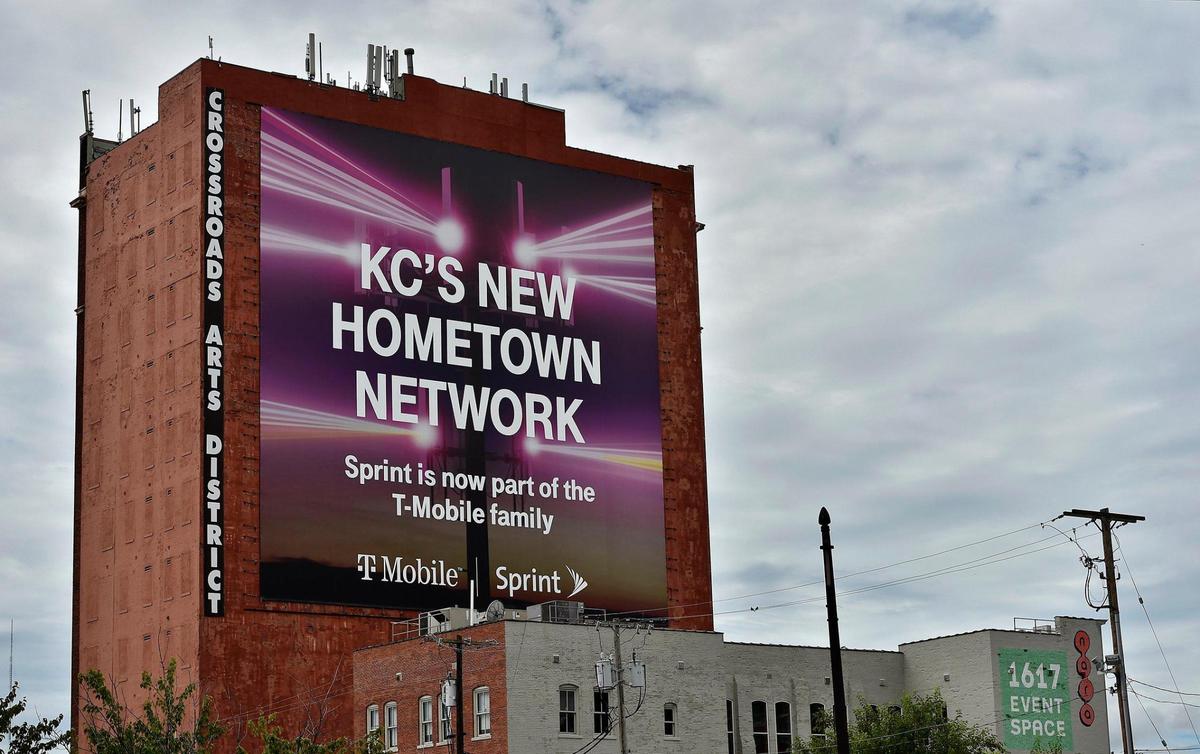 A large sign on a building at Main and 17th streets tells the public of the merger between Sprint and T-Mobile.
