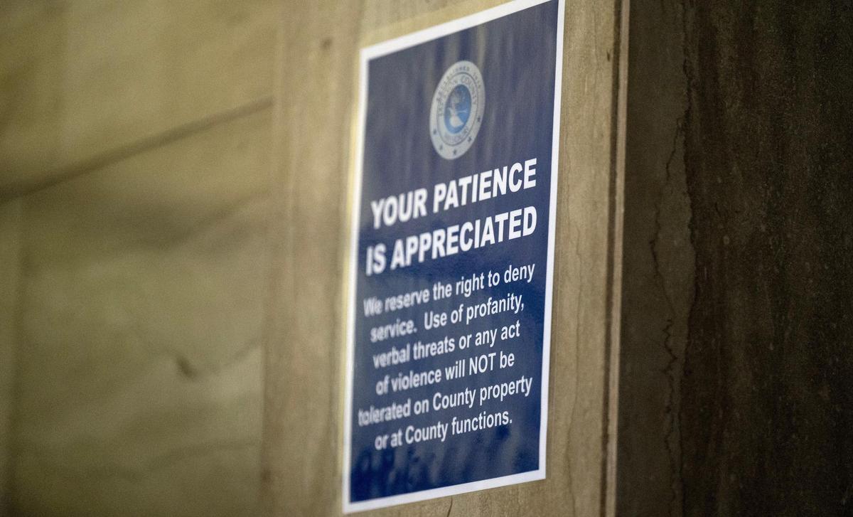 A sign urges people to act respectfully while waiting to register personal property documents with the Jackson County Assessment office on Friday, March 29, 2024, in Independence, Missouri.