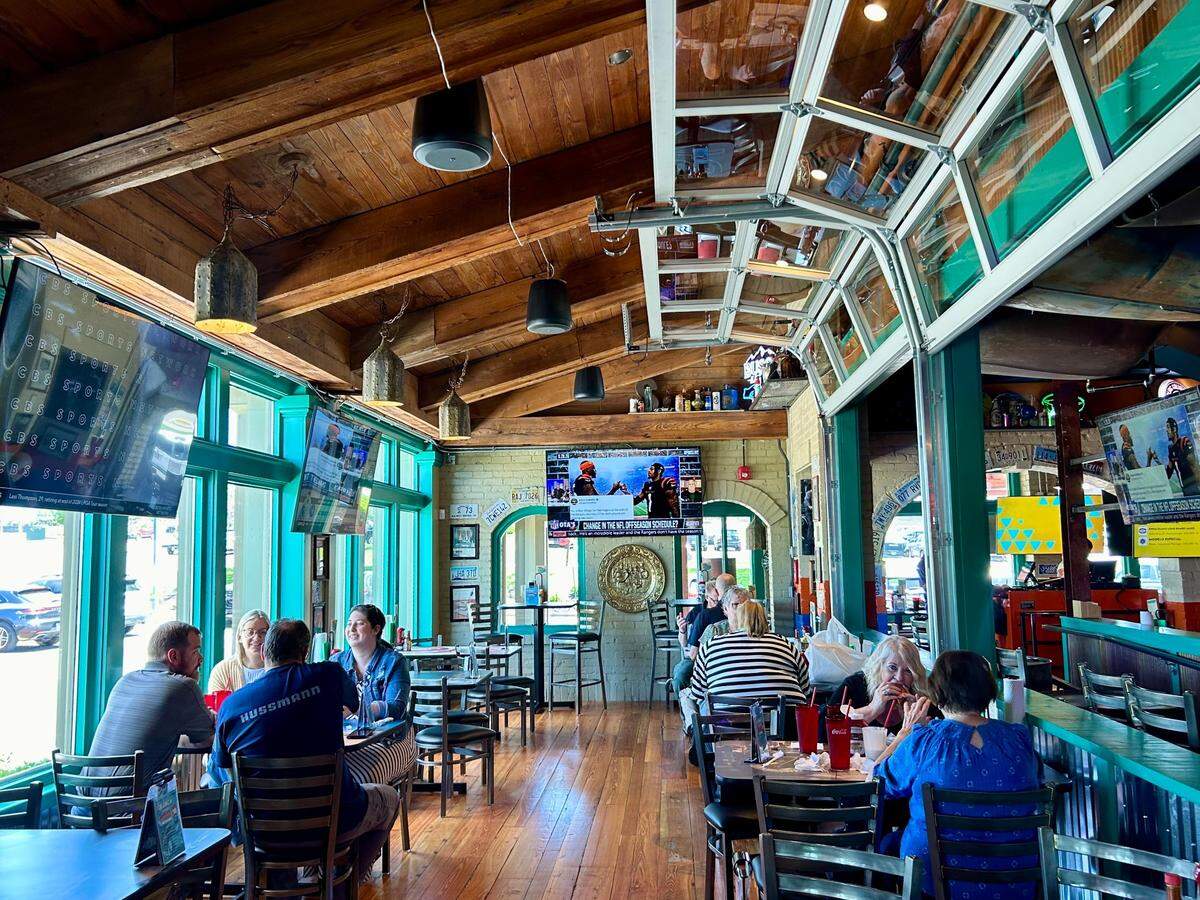 Garage doors open to a side dining room in Sickies Garage, Overland Park’s newest burger restaurant.