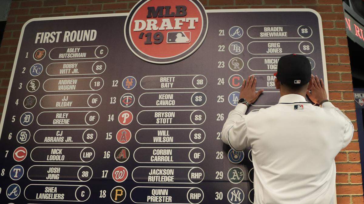 Daniel Espino, a right handed pitcher from the Georgia Premier Academy, in Statesboro, Ga., places his name on the draft board after being selected No. 24 by the Cleveland Indians in the first round of the Major League Baseball draft, Monday, June 3, 2019, in Secaucus, N.J. (AP Photo/Julio Cortez)