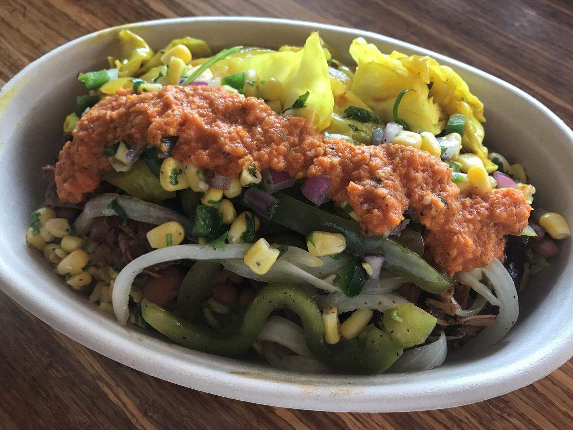 Taste Island Grill’s Reggae Vibs with jerk chicken, curried brown rice, pinto beans, peppers, onions, steamed cabbage and corn salsa.