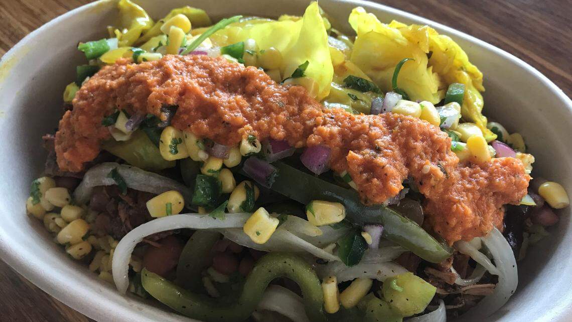 Taste Island Grill’s Reggae Vibes bowl: jerk chicken, curried brown rice, pinto beans, peppers, onions, steamed cabbage and corn salsa.