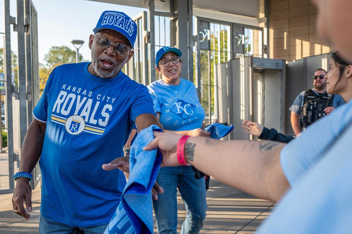 Joel Estes grabs a rally towel at the entrance B before Game 4 of the American League Division Series between the Kansas City Royals and the New York Yankees on Thursday, Oct. 10, 2024, at Kauffman Stadium.