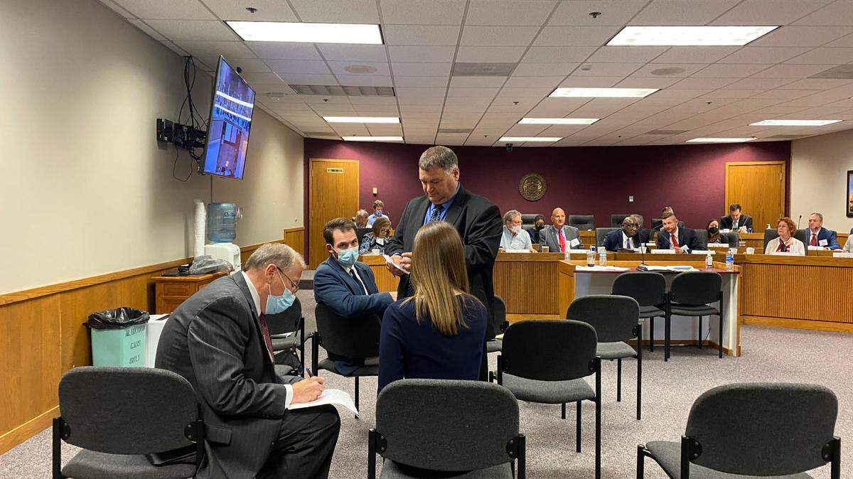 Jim McAdams, deputy commissioner and general counsel of the Missouri Office of Administration, left, and other OA employees tally secret-ballot votes in a procedural dispute of the House Independent Bipartisan Citizens Commission Tuesday evening. Partisan bickering and deadlocks ruled the first meeting of the group, which is tasked with redrawing the House district map for the next 10 years.