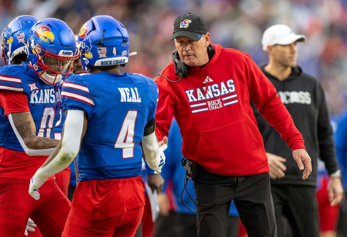 Kansas Jayhawks running back Devin Neal (4) is congratulated by coach Lance Leipold after scoring a touchdown against the Colorado Buffaloes during the first half at GEHA Field at Arrowhead Stadium on Saturday, Nov. 23, 2024, in Kansas City.