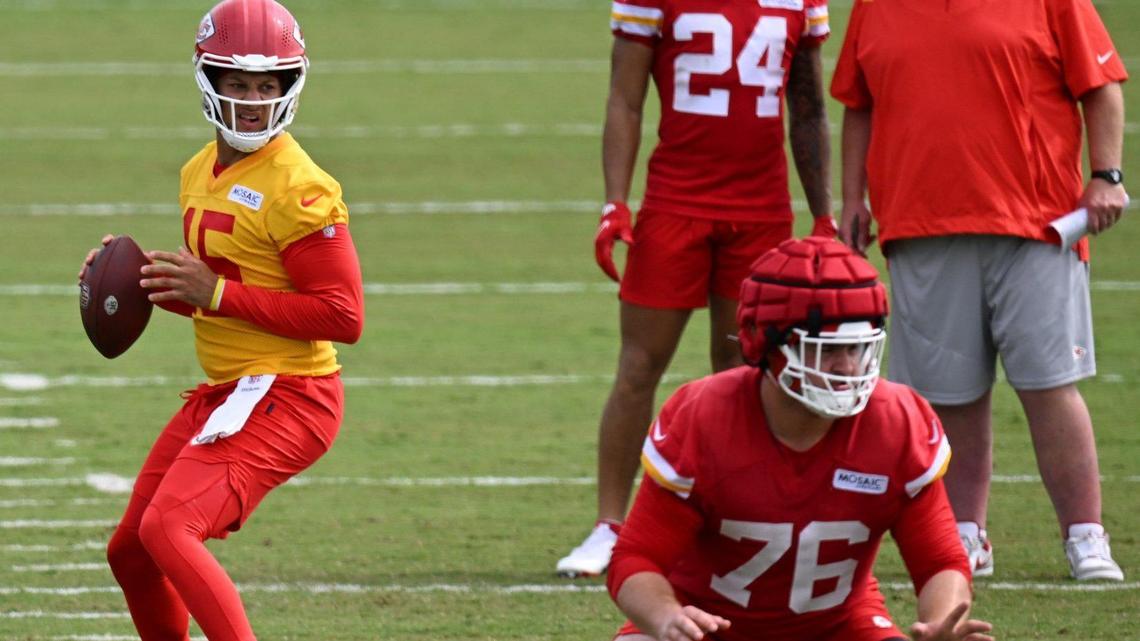 Chiefs quarterback Patrick Mahomes (15) looks for a receiver during training camp on Friday, July 29, 2022 at Missouri Western State University, in St. Joseph, Missouri. Guard Vitaliy Gurman (76) was in on the play as wide receiver Skyy Moore (24) talked with head coach Andy Reid.