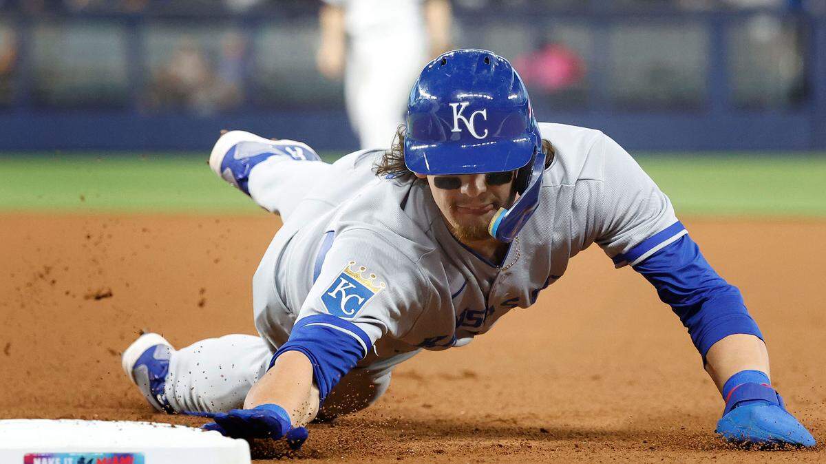 Kansas City Royals shortstop Bobby Witt Jr. (7) dives back safely to first base during the first inning at loanDepot Park on June 6, 2023.