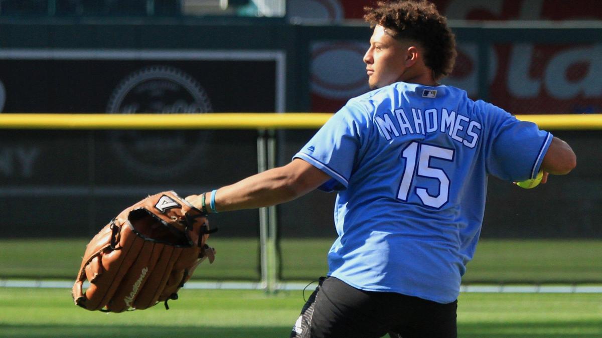 Getting in on the comedy, Kansas City Chiefs quarterback Patrick Mahomes looks to throw out a runner with an oversized glove on Friday at the Big Slick Celebrity Softball game at Kauffman Stadium.