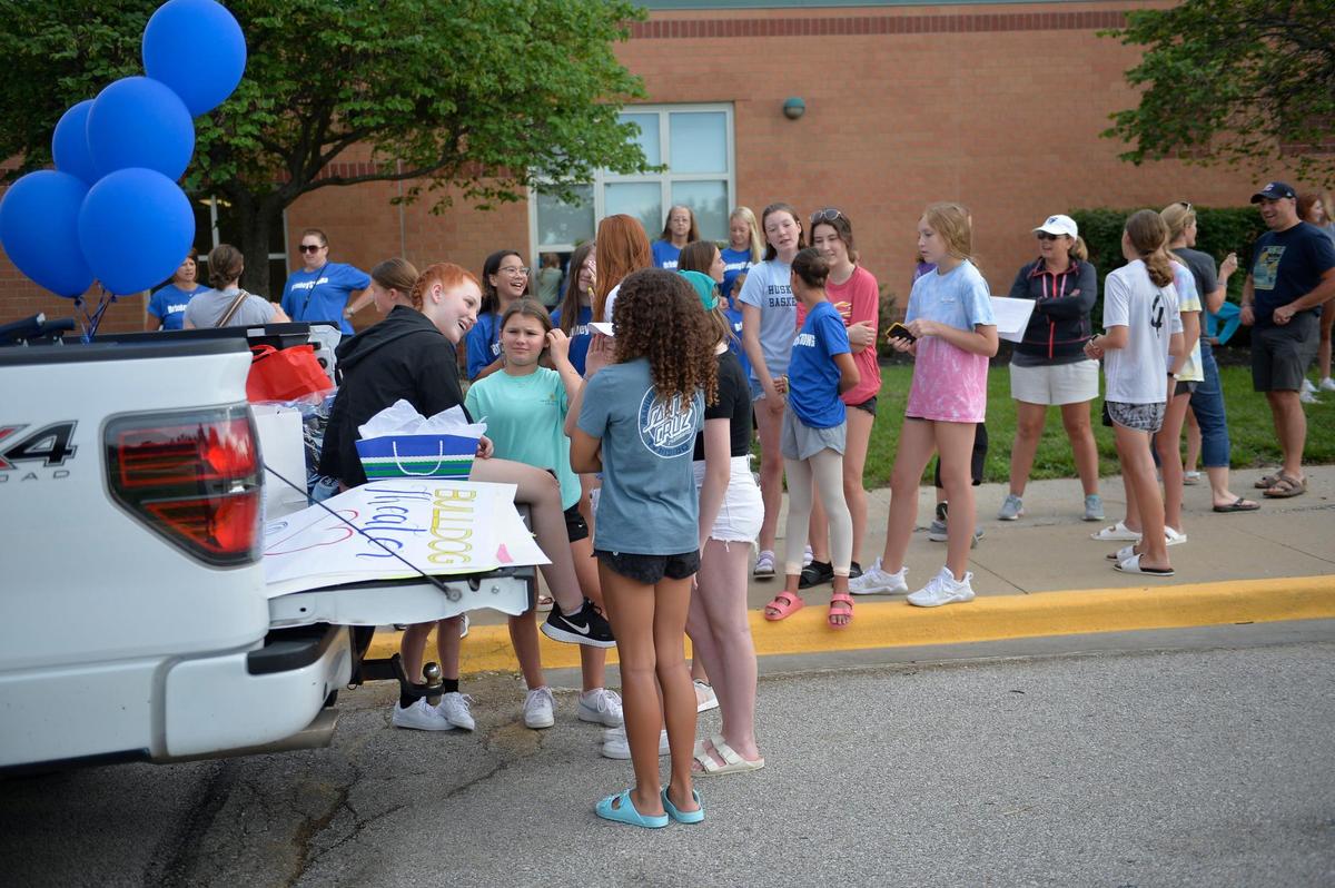Brinley Hutson, 12, talks with friends after they welcome her, Monday, July 12, 2021 at California Trail Middle School in Olathe. This is the first time she has seen some friends, coaches and community members since having surgery.