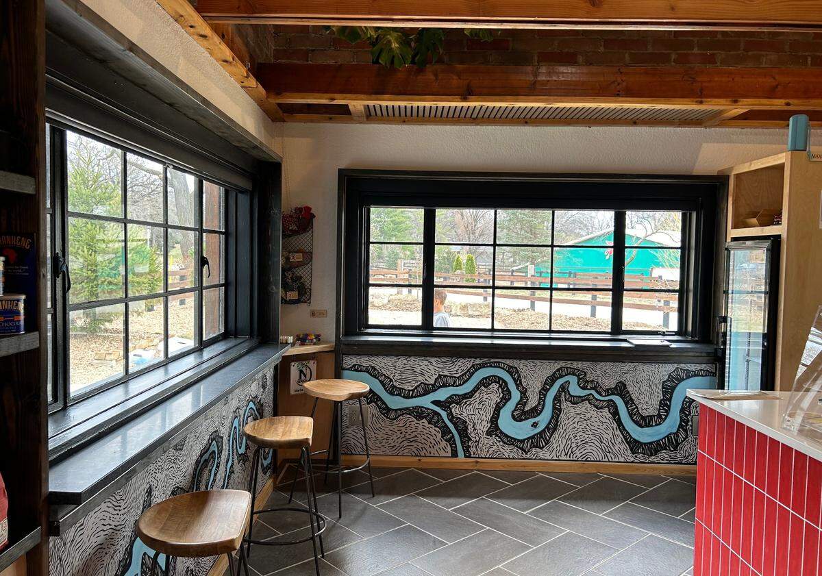 A mural of Mill Creek and Little Mill Creek wraps around one half of the coffee shop.