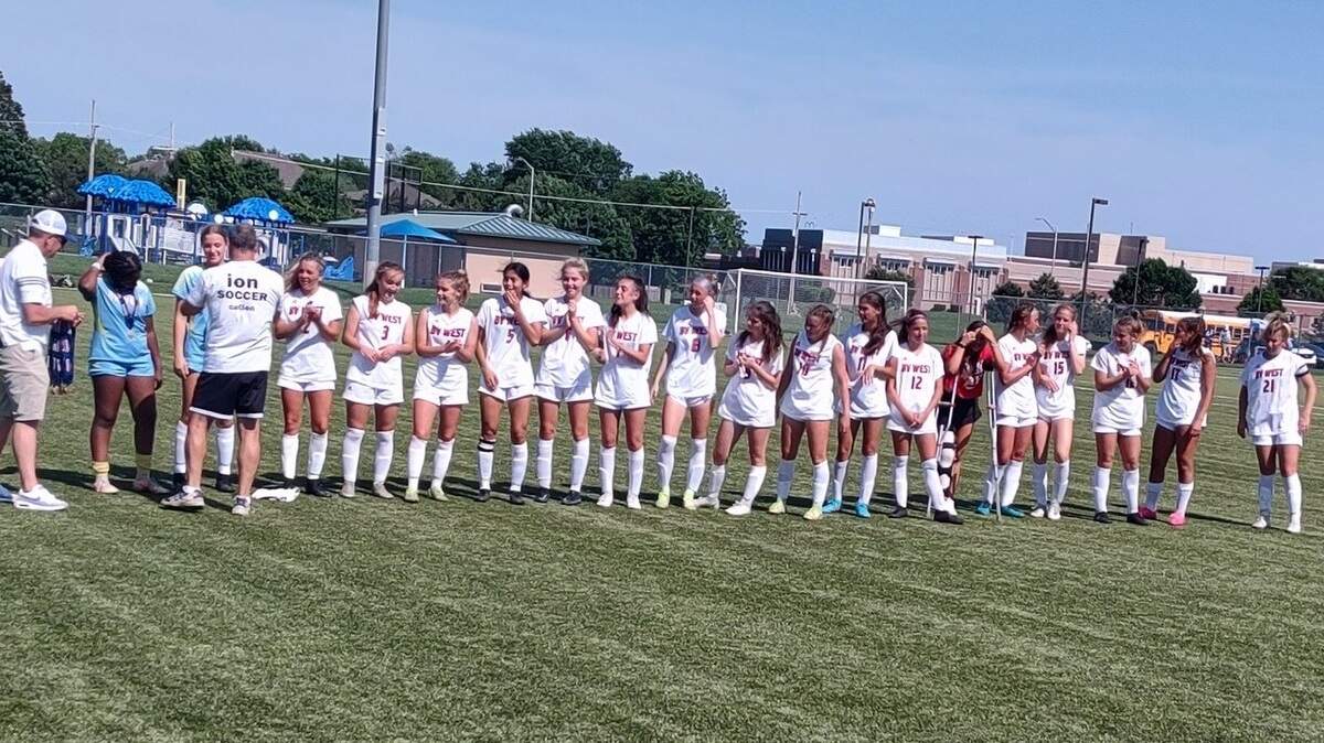 Members of the Kansas Class 6A state champion Blue Valley West Jaguars accept their medals after beating Washburn Rural for the title on Saturday at College Boulevard Activity Center in Olathe.