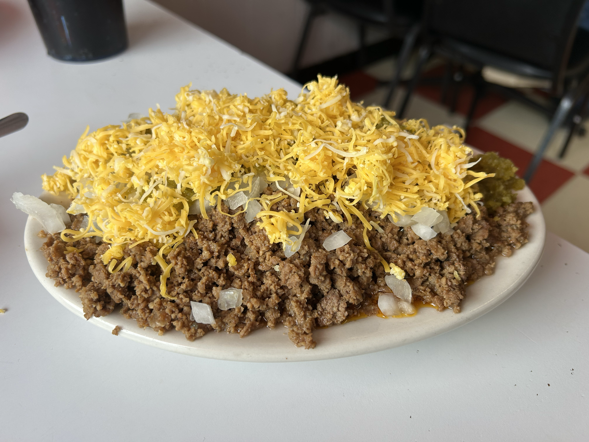 Owner Stephen Steffes said the correct way to enjoy Dixon’s is with a smattering of toppings, including shredded cheese, chopped onions and homemade hot vinegar.