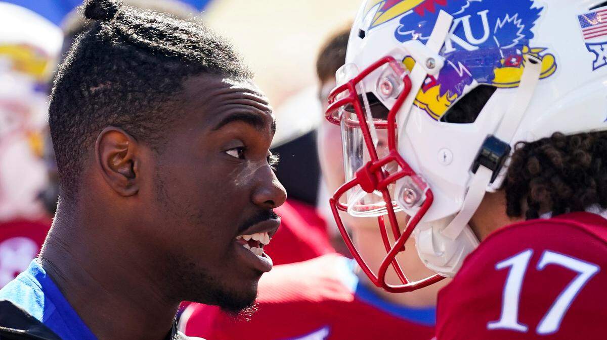 Kansas quarterback Jalon Daniels (6) talks with quarterback Jason Bean (17) after leaving the game with an injury during the second half against TCU at David Booth Kansas Memorial Stadium on Oct. 8, 2022.
