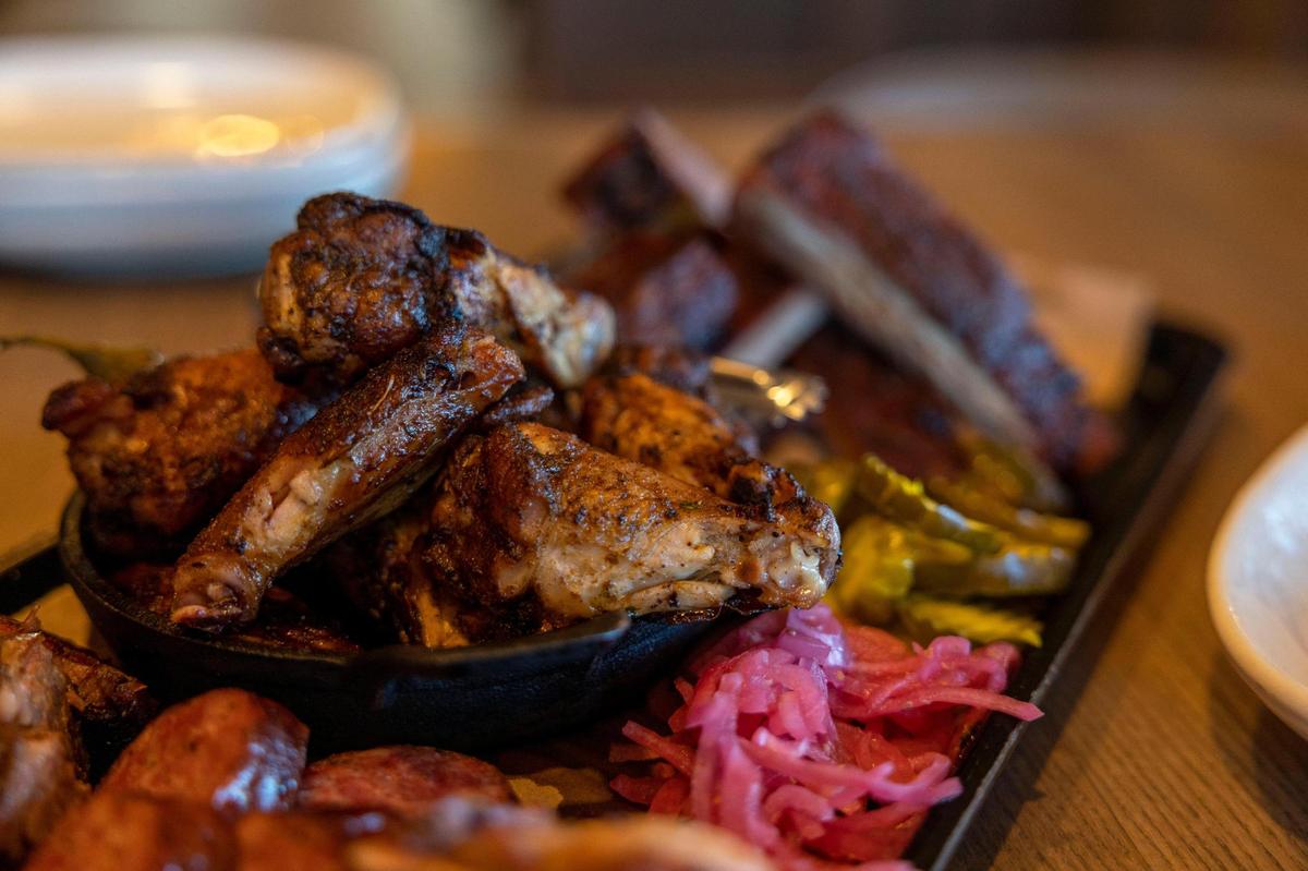 A variety of grilled meat sits on a table at Jack Stack Barbecue in Kansas City on Friday, Jan. 28, 2022. Kansas City Mayor Quinton Lucas is waging a barbecue bid against Cincinnati Mayor Aftab Pureval for Sunday’s AFC Championship game against the Bengals.