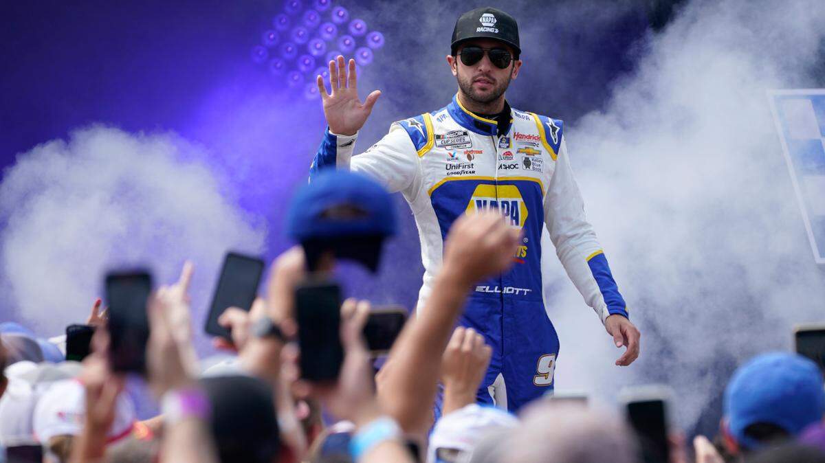 Chase Elliott greets fans during driver introductions prior to the start of a NASCAR Cup Series auto race at Richmond Raceway, Sunday, Aug. 14, 2022, in Richmond, Va. (AP Photo/Steve Helber)