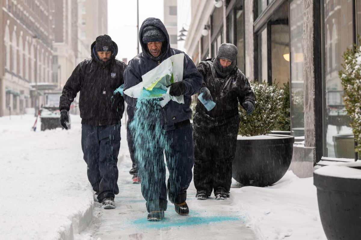 David Sims and other Power & Light workers spread ice melt in downtown Kansas City on Sunday, Jan. 5, 2025.