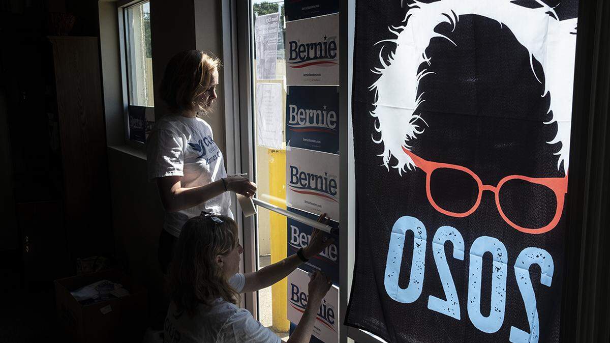 Volunteers put the finishing touches on their new campaign office as they await the arrival of Sen. Bernie Sanders in Iowa City, Iowa, on July 3.