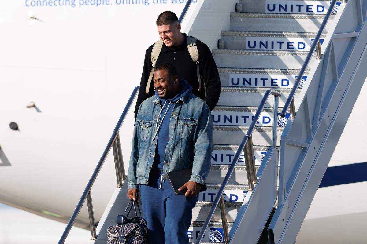 Kansas City Chiefs defensive linemen Chris Jones and George Karlaftis exit the plane after arriving at Louis Armstrong New Orleans International Airport on Feb. 2, 2025.