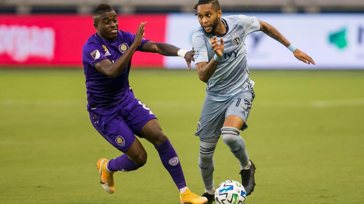 Sporting Kansas City defender Amadou Dia (13) attempts to maneuver past the defense of Orlando City midfielder Sebas Mendez (8) during the game between Sporting Kansas City and Orlando City SC on Wednesday September 23, 2020 at Children’s Mercy Park in Kansas City, Kansas.